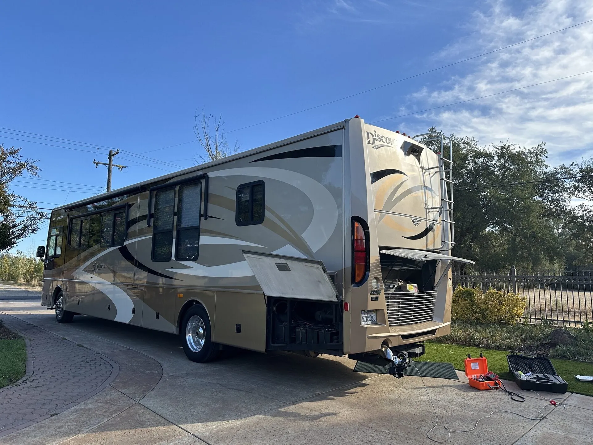 Class A diesel motorhome with engine bay open during mobile CARB Clean Truck Check testing