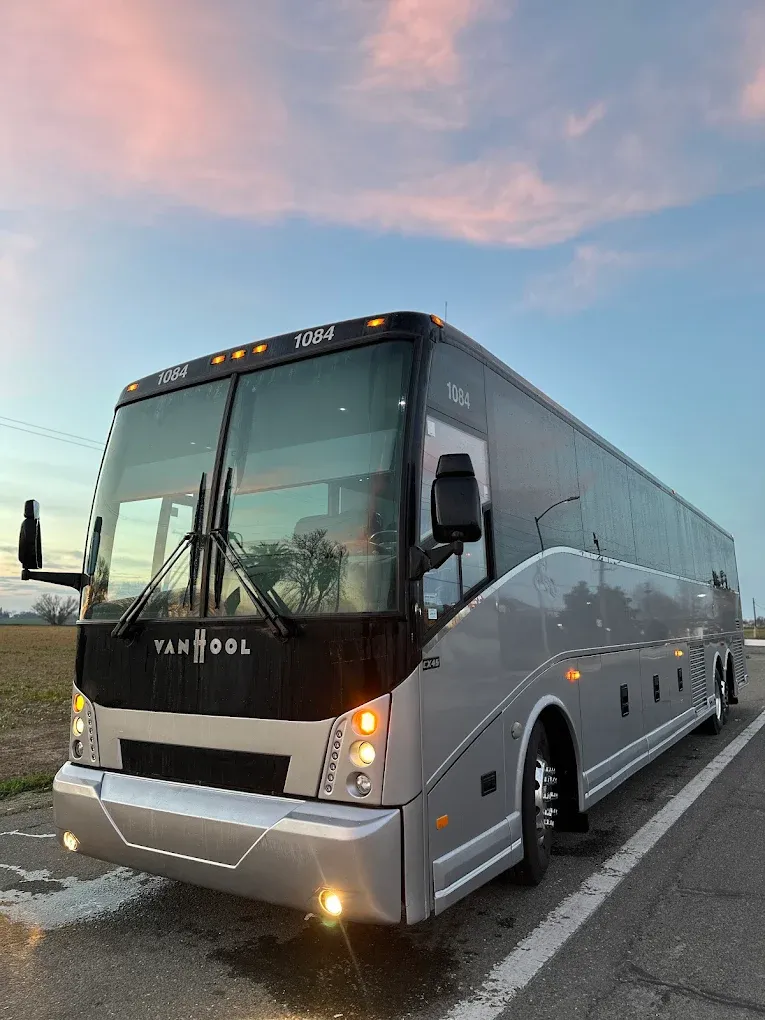 Van Hool CX45 motorcoach parked at sunset before a mobile CARB Clean Truck Check in Northern California